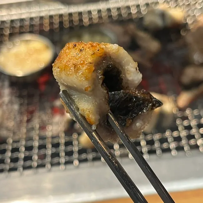 Eel and pork belly grilling together on the plate