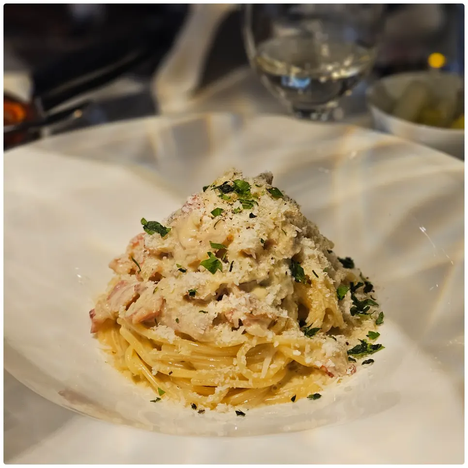 Carbonara spaghetti topped with snow-like cheese