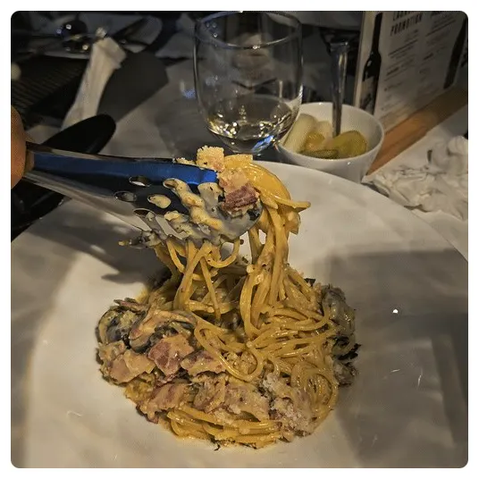 Carbonara noodles twirled around a fork