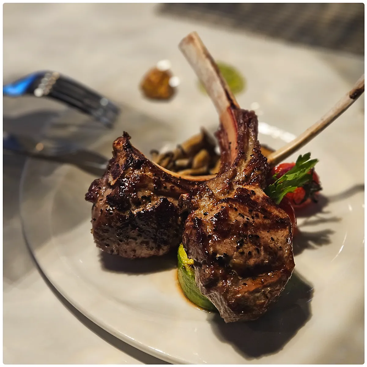 Lamb chop steak plated with garnishes