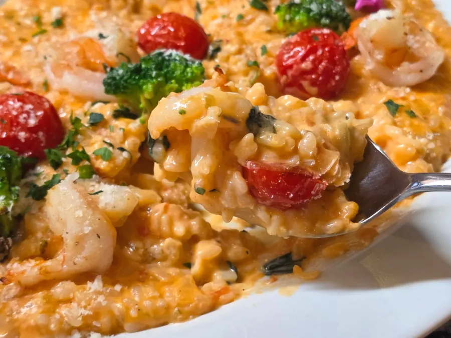 Rosé risotto topped with plump shrimp