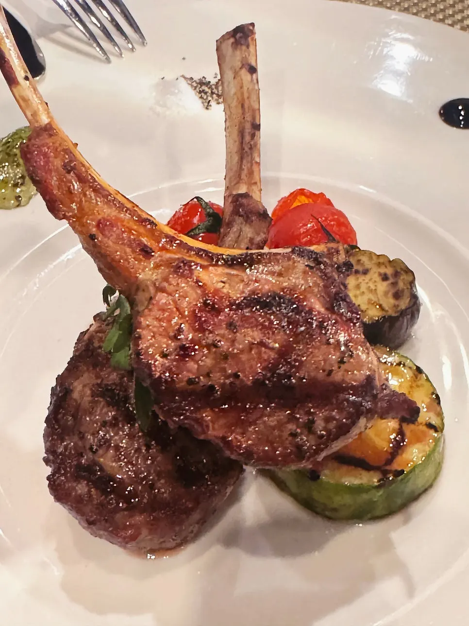 Lamb chop steak plated with several sauces