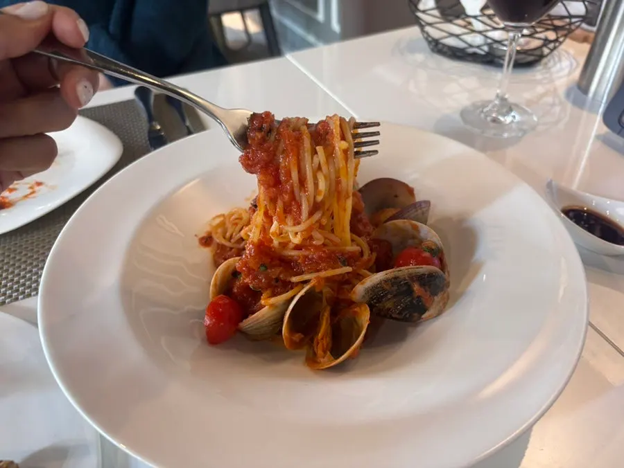 A forkful of spaghetti coated in tomato sauce