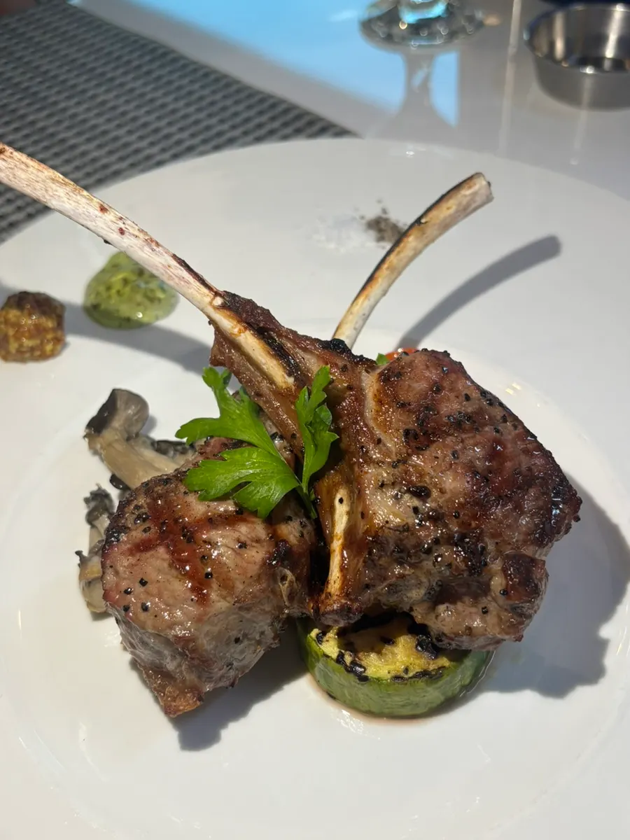 Lamb rack steak plated with grilled vegetables