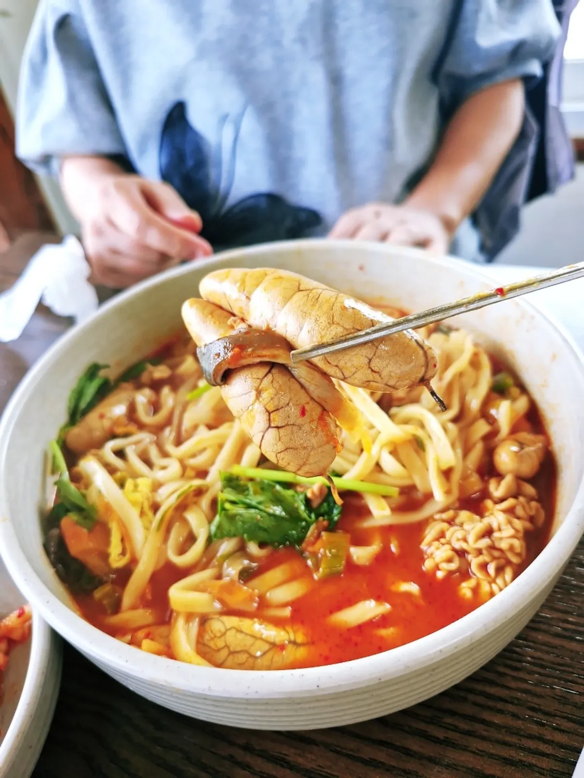 Vertical photo of the kalguksu table setting at Todamok in Seonbu-dong, Ansan