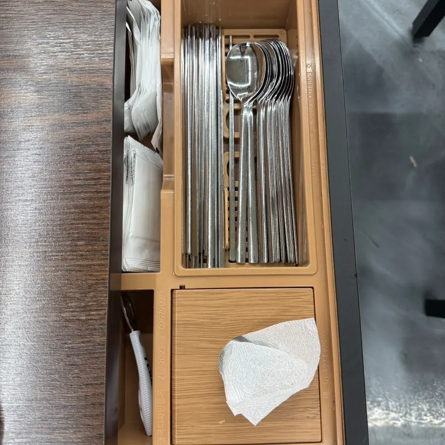 Seasonings, soy sauce, and cups on the table