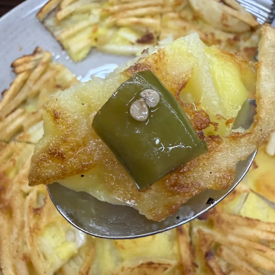 Potato pancake dipped in wasabi soy sauce