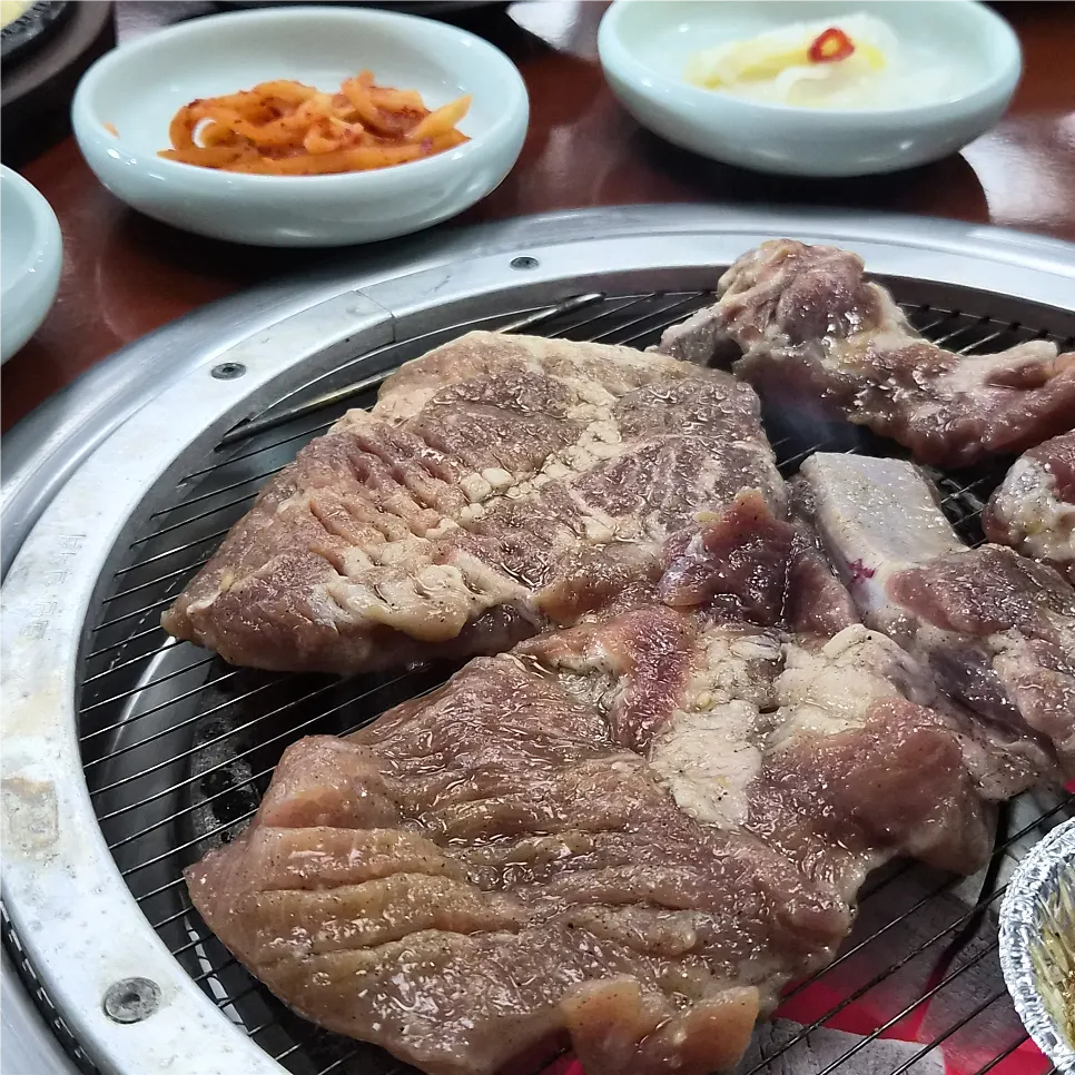 Pork ribs grilling over charcoal