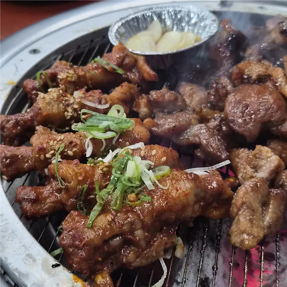 Spicy chicken feet grilling over charcoal