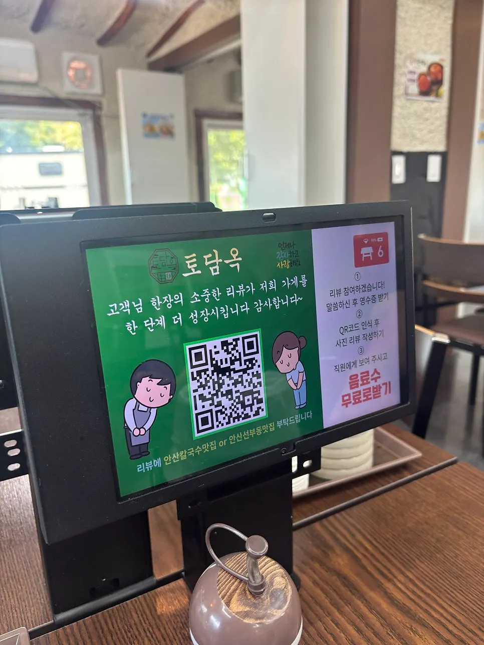 갈색 식탁과 높은 층고의 매장 내부