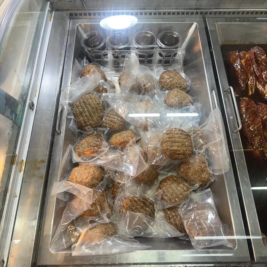 Refrigerated case displaying handmade marinated meats