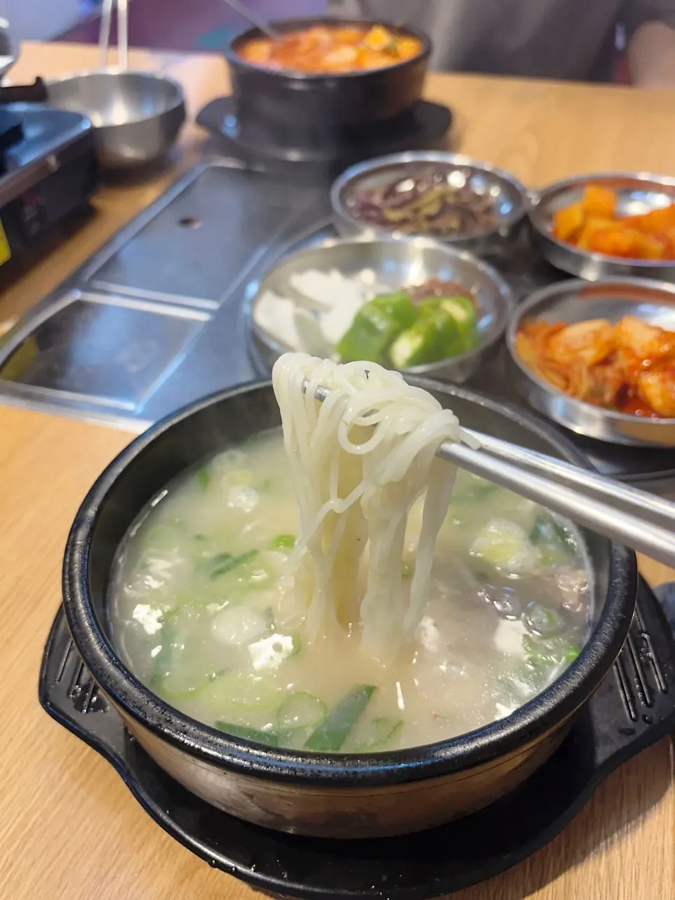 Close-up of the seolleongtang broth with meat and noodles