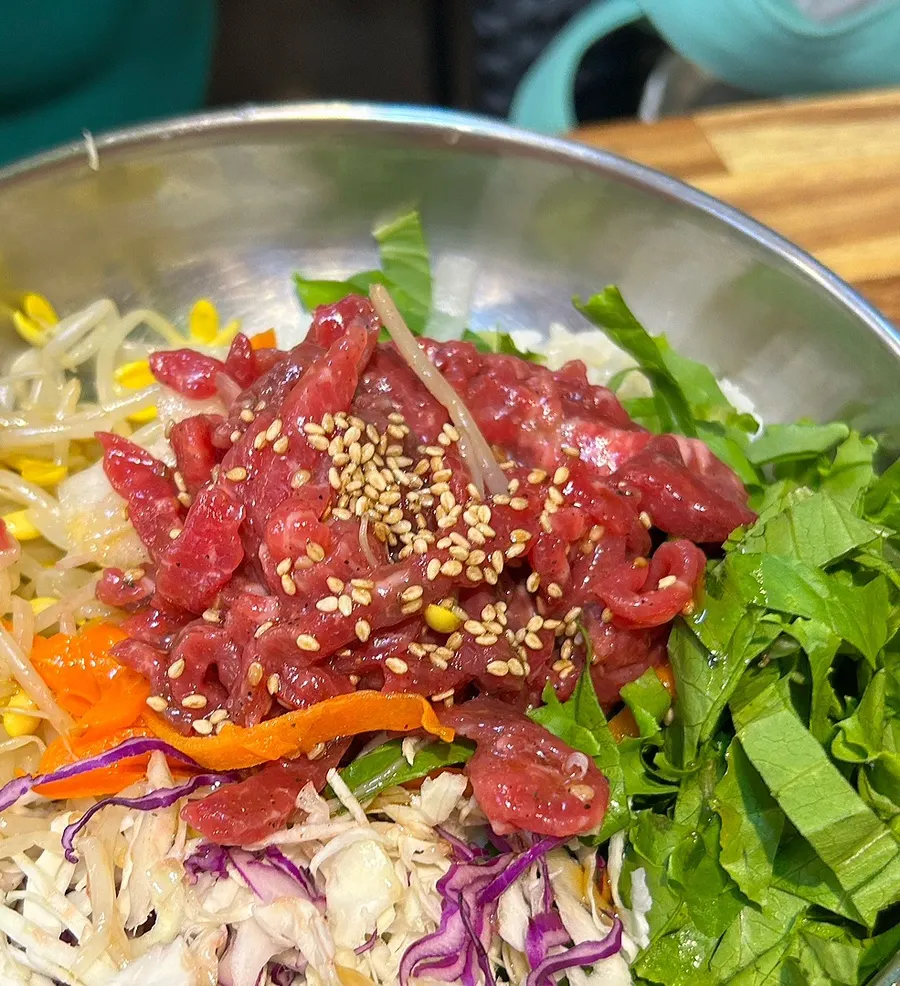 Yukhoe bibimbap topped generously with raw beef