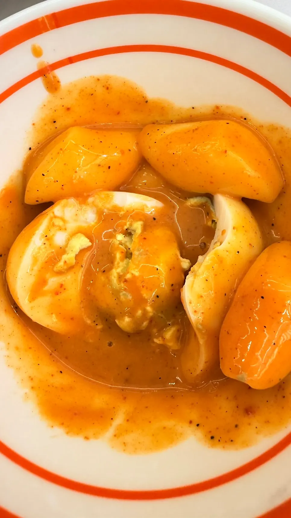 Boiled egg served with spicy tteokbokki sauce