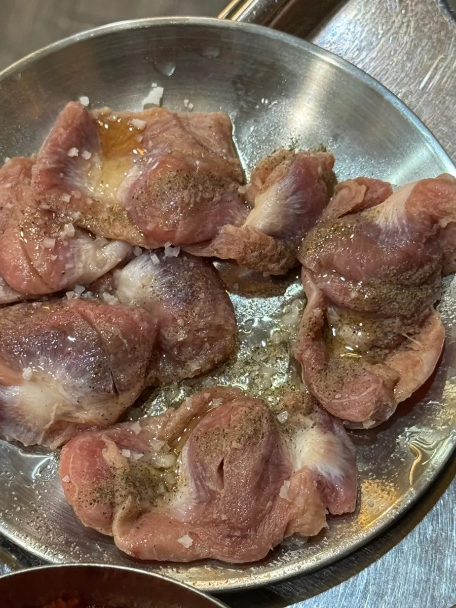 Boneless chicken feet grilling over charcoal