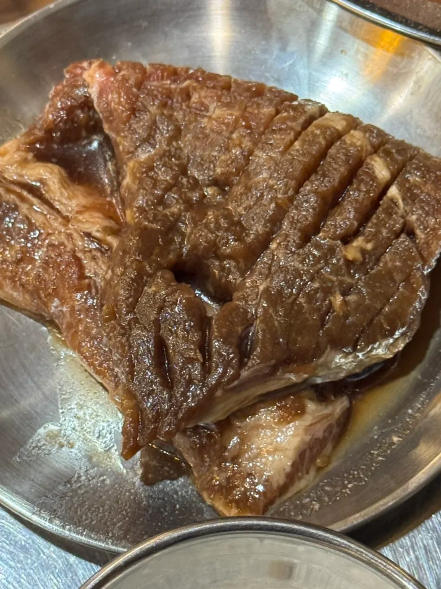 Picking up a piece of pork skirt steak