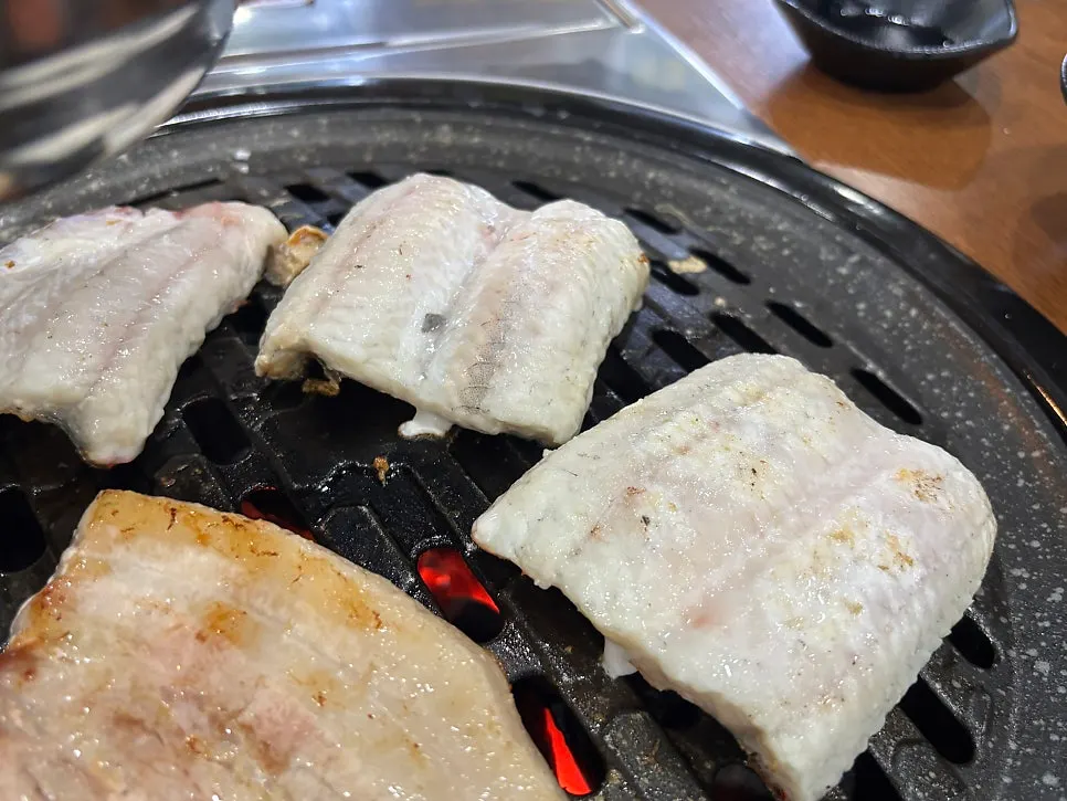 Skin side of eel grilling on the grate