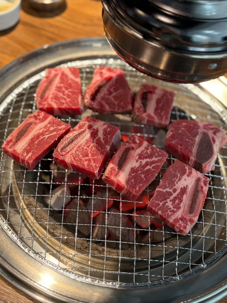 Beef grilling over charcoal