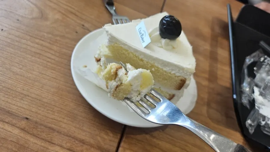 A slice of cream cake at Chat Baker