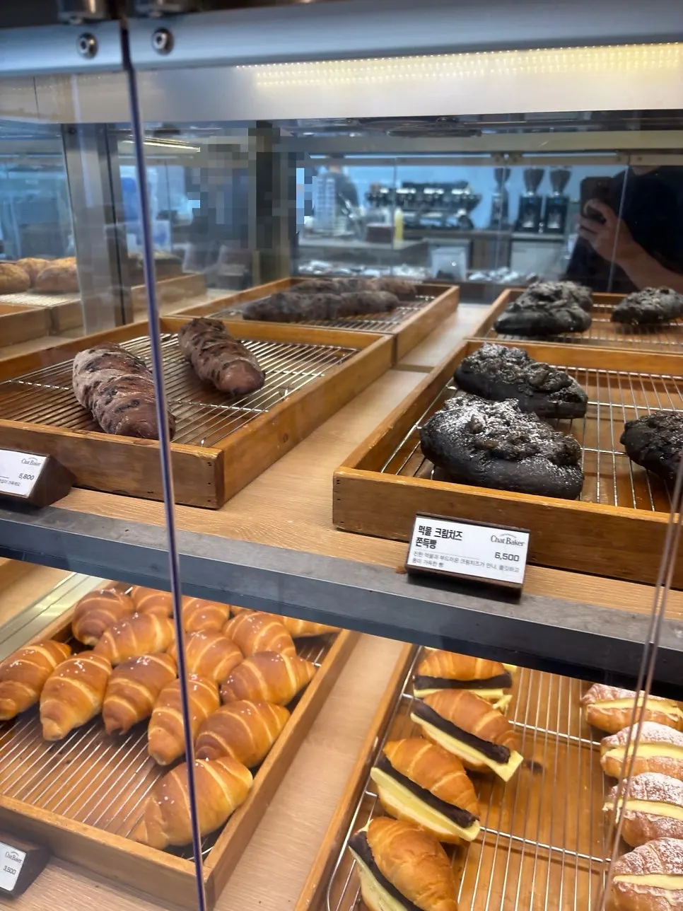 Rows of bread lined up on the counter at Chat Baker