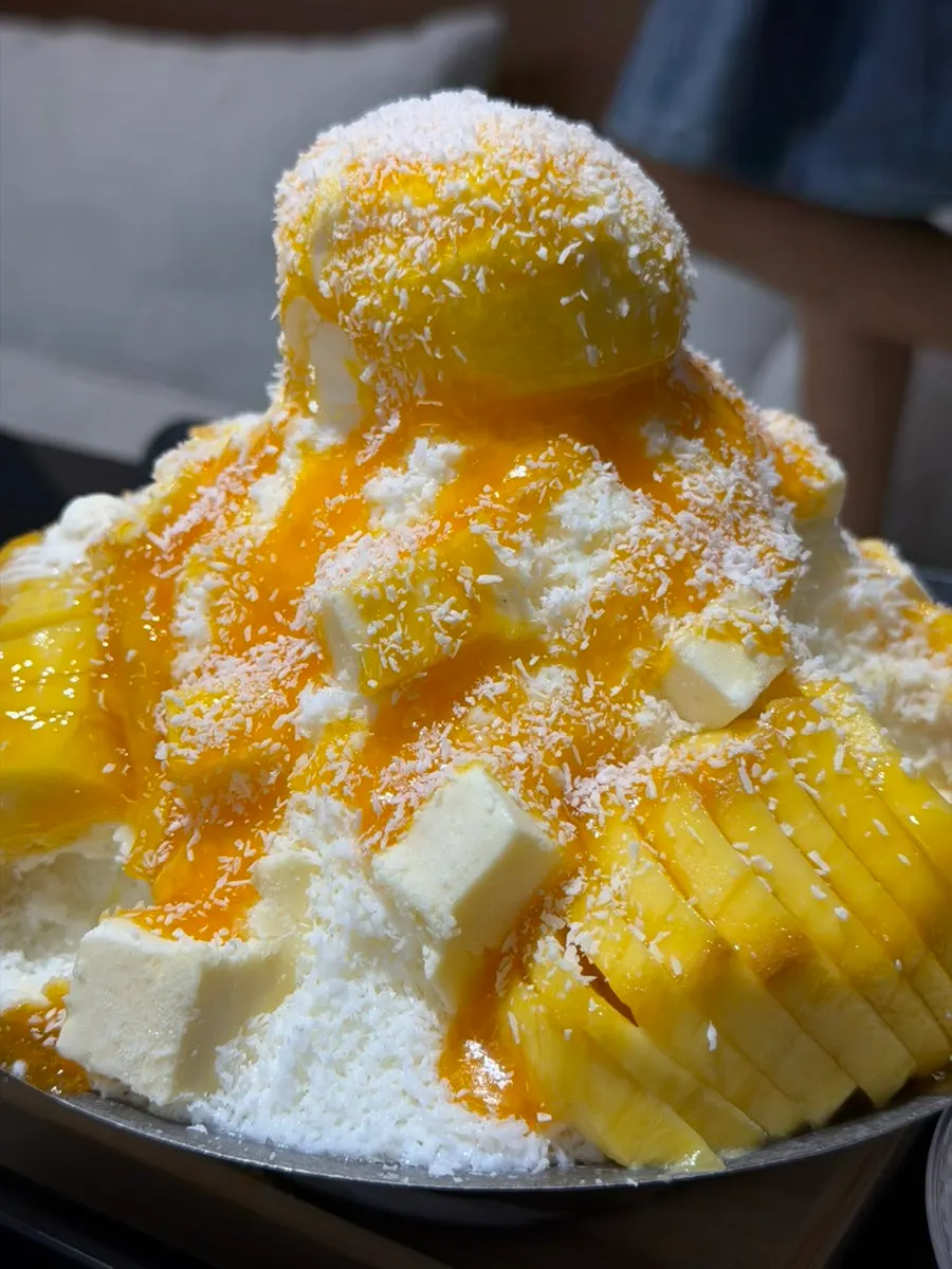Milk snow-flake ice with frozen mango layered underneath