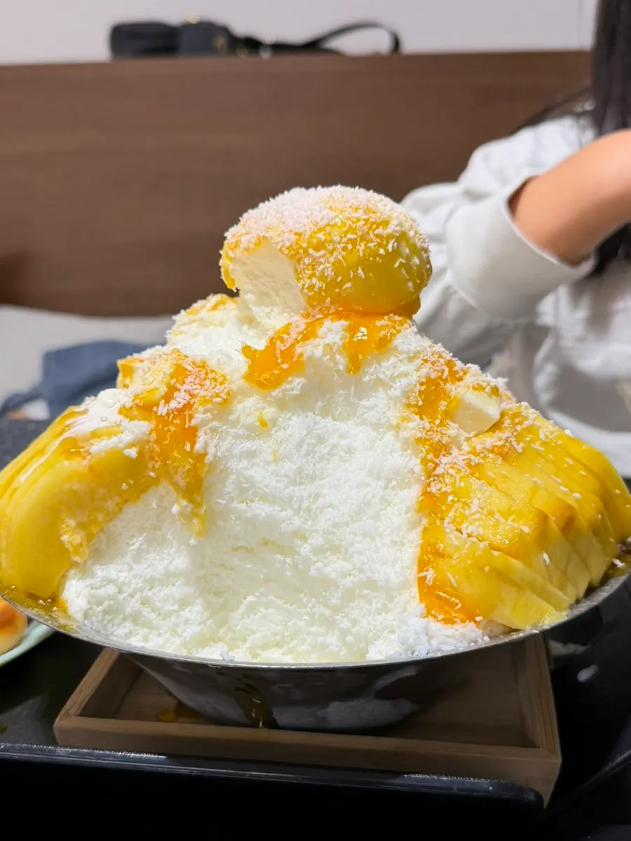 Eating the coconut fresh mango bingsu