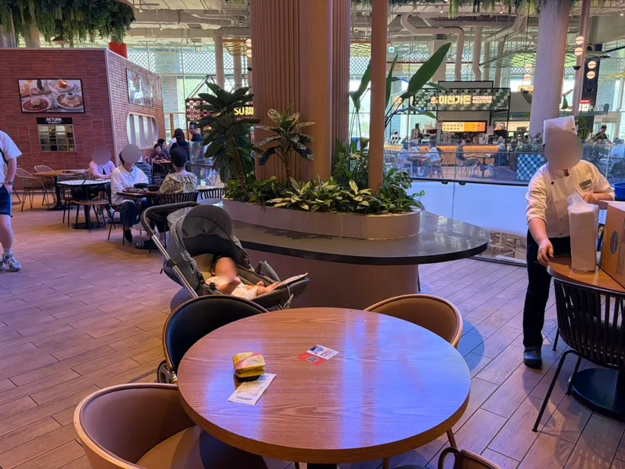 Baby already seated at the food court table