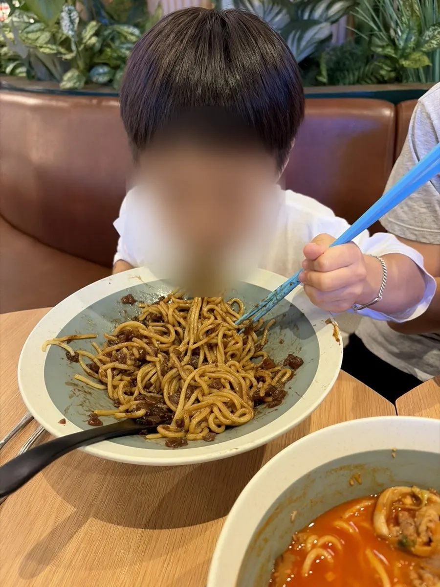 Child holding adult chopsticks