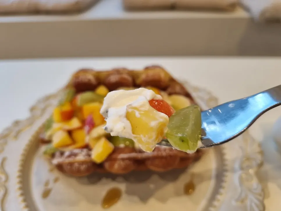 Cross-section of the Hong Kong waffle with whipped cream and fruit