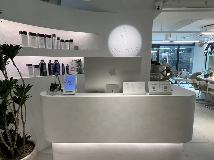 Professional hair products displayed next to the reception desk