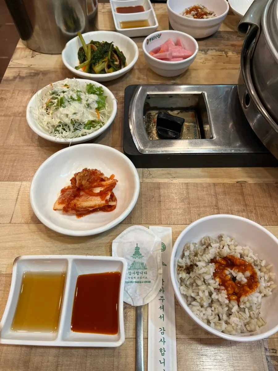 Table set with side dishes and barley rice