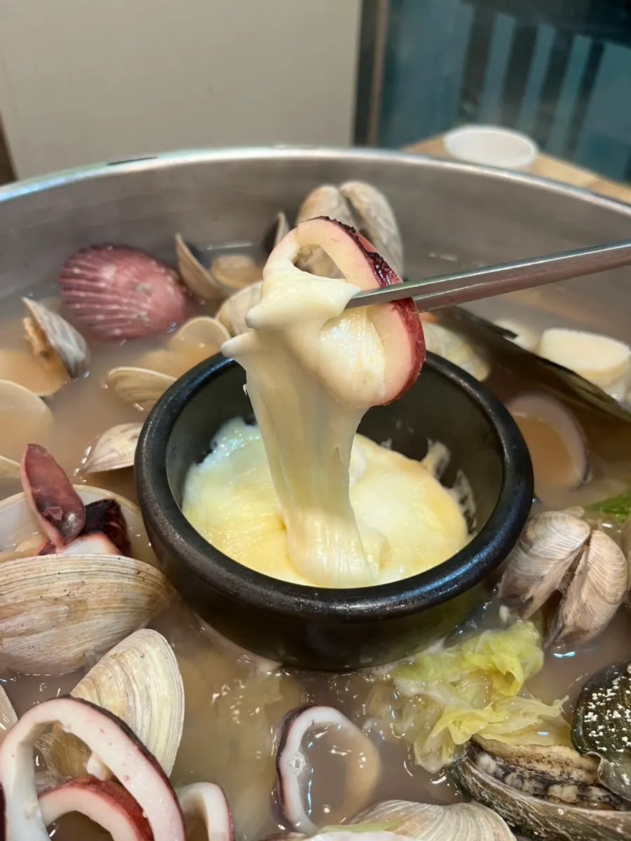 Squid being dipped into the cheese