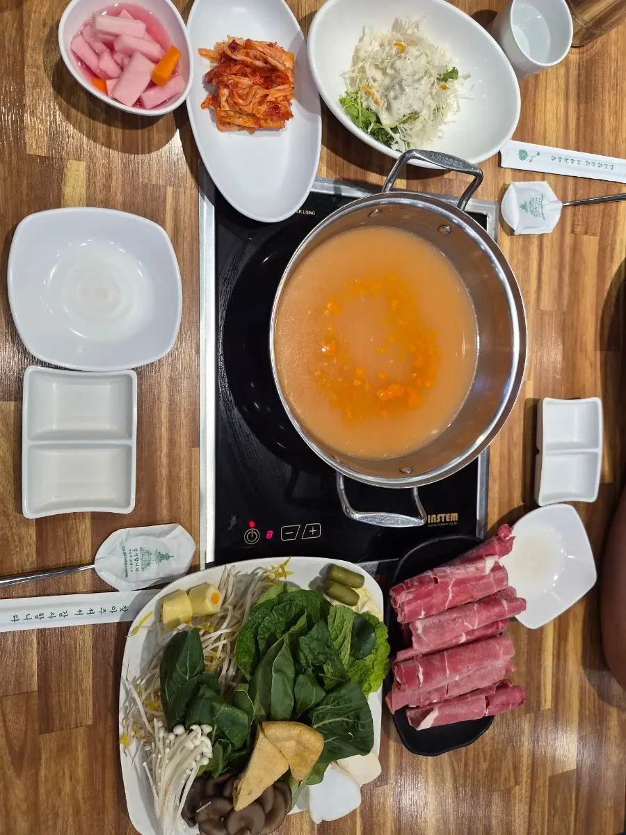 Plate of shabu-shabu vegetables and beef ingredients
