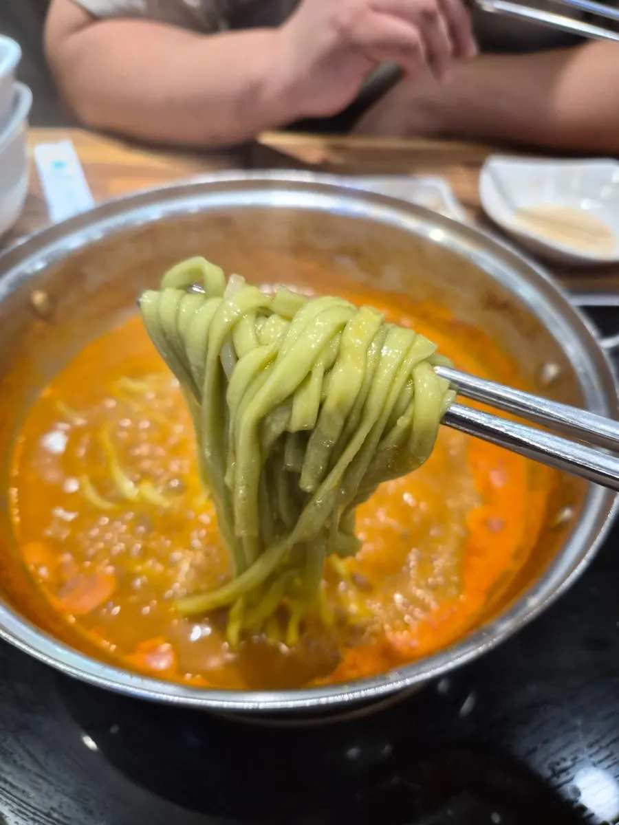 Plate of green-tinted rice cakes and noodles made with mulberry leaf