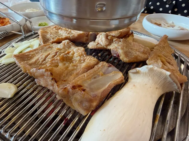 Pork galbi placed on a charcoal grill