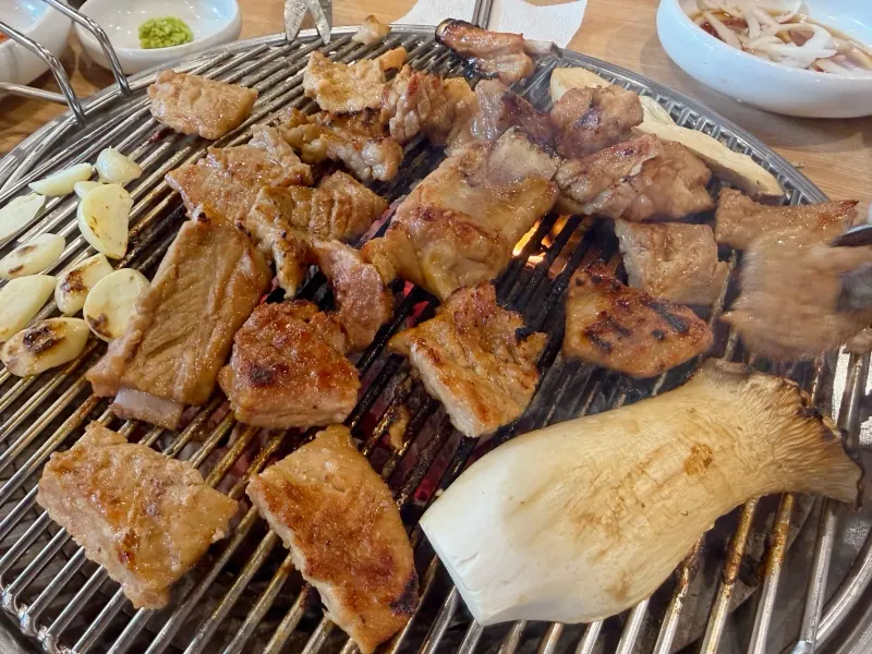 Marinated pork galbi grilling on the grate