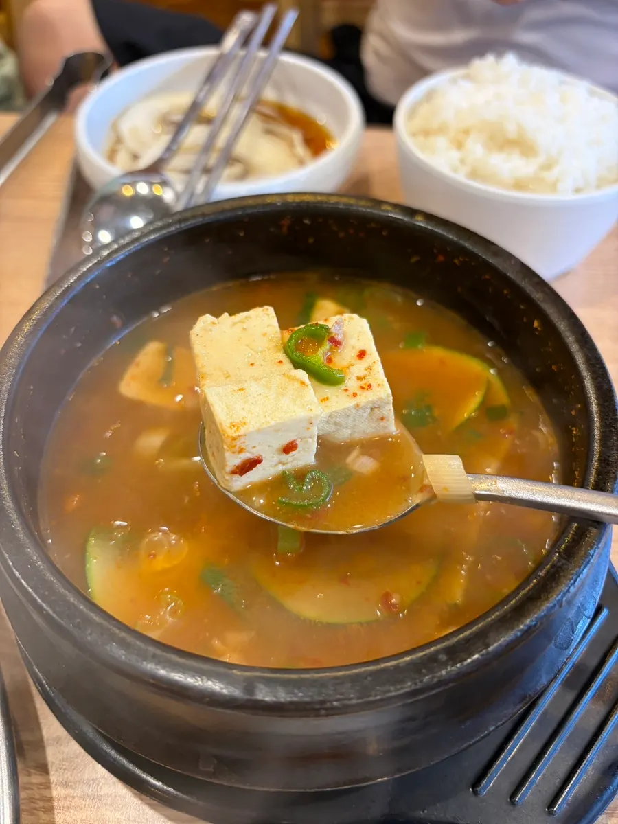 Ordered white rice and doenjang-jjigae table setting
