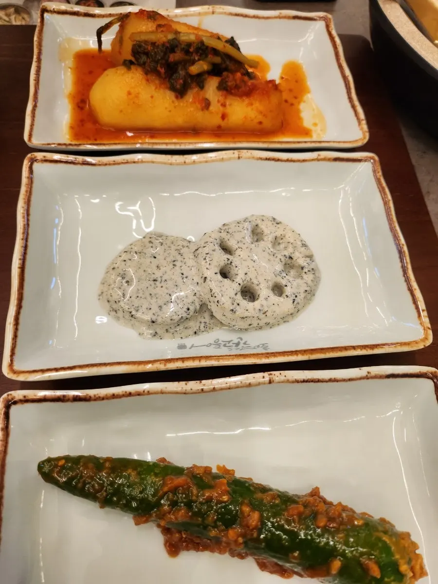 Rice topped with bracken fern and mackerel flesh