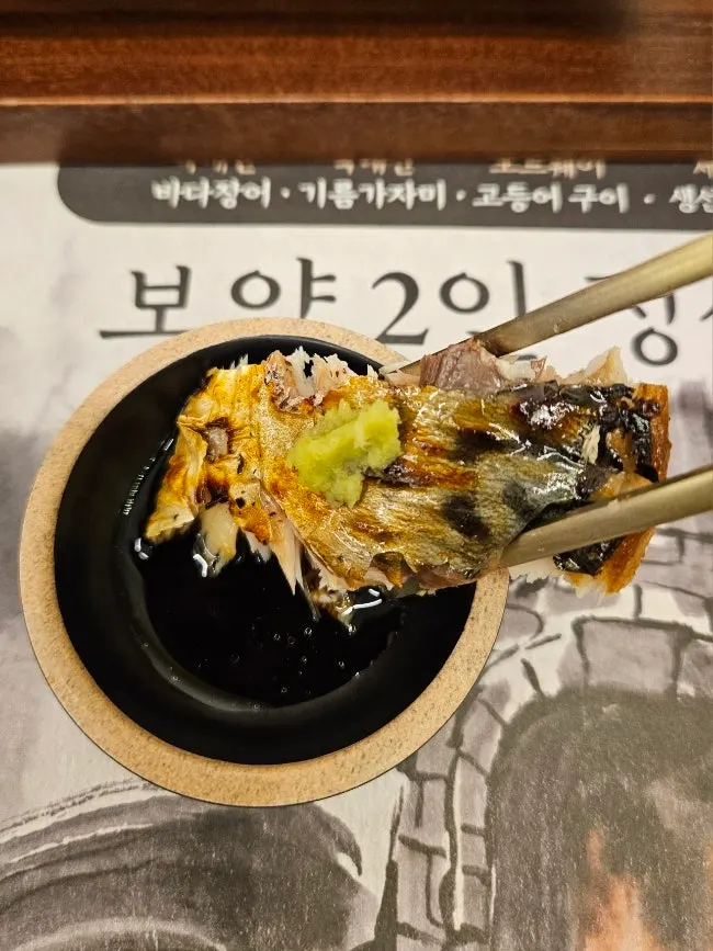 Grilled fish served with a bowl of rice