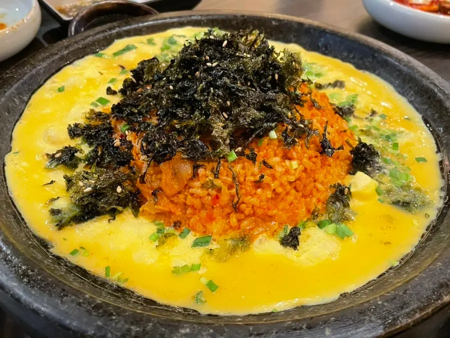 Fried rice being pressed and cooked on the grill