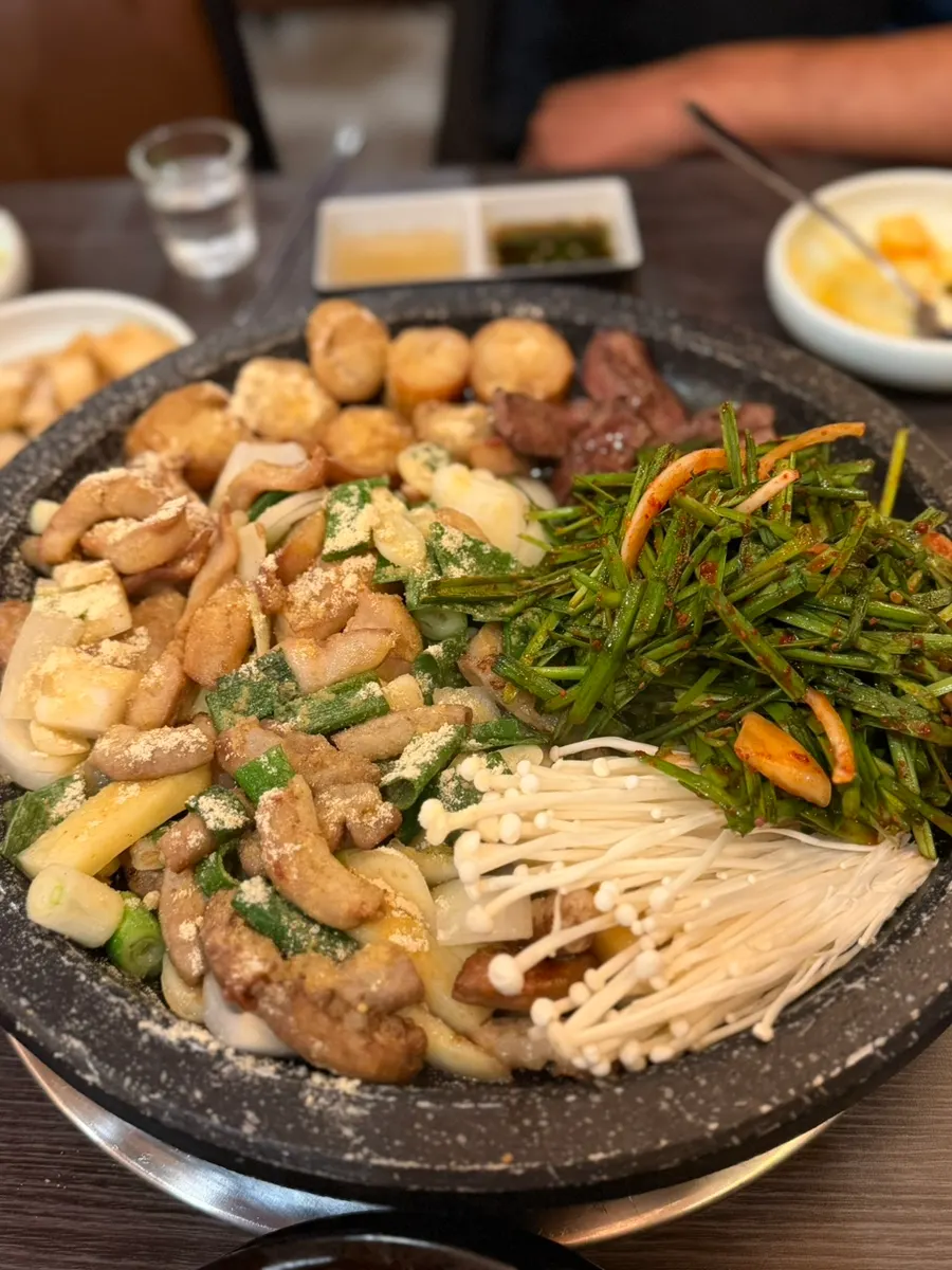 Table with gopchang and Korean beef tartare mulhoe at Ilmigop
