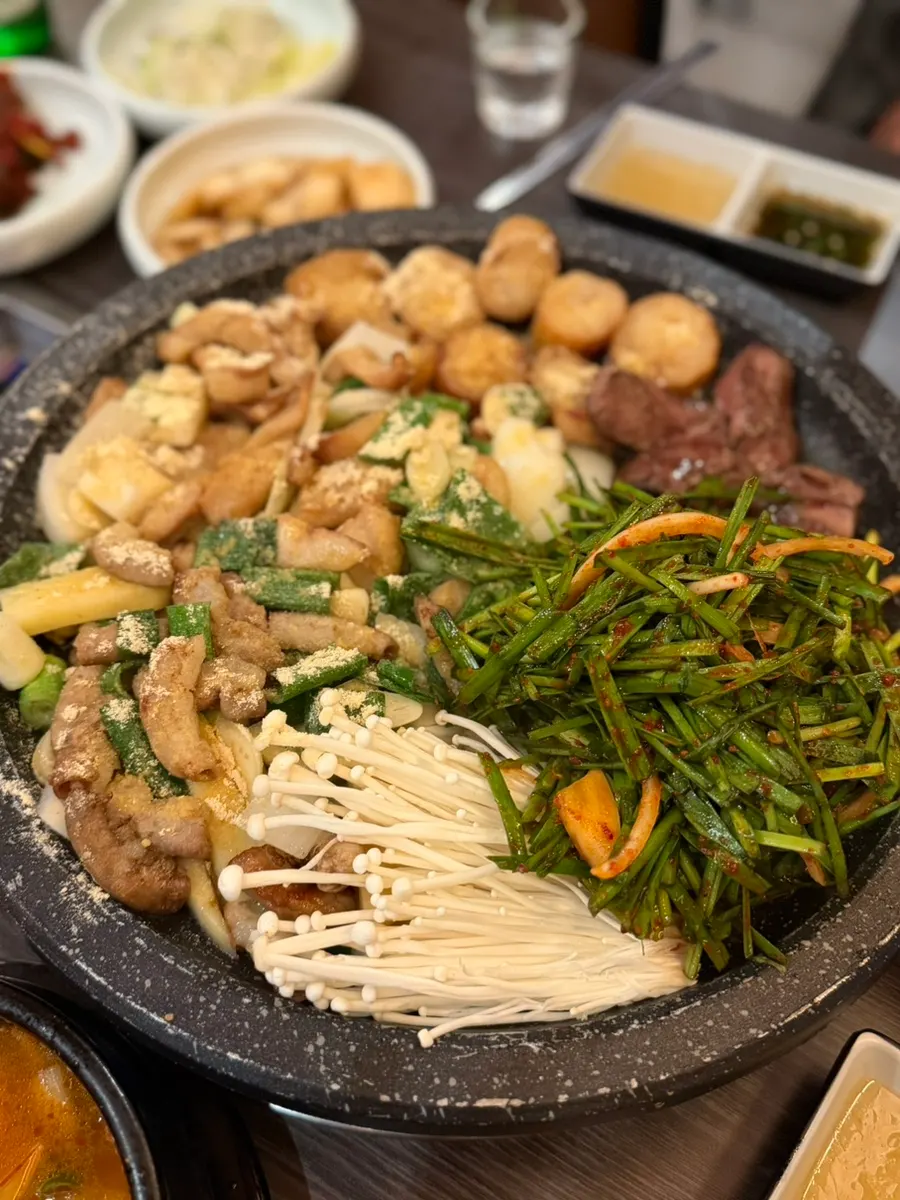 Assorted gopchang cooking on the grill