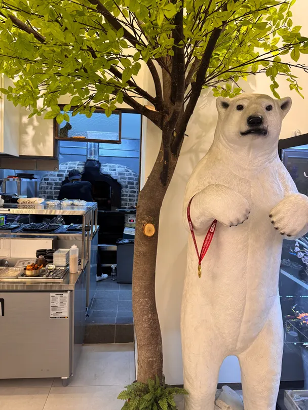 Large white bear and wood decoration on one side of the restaurant