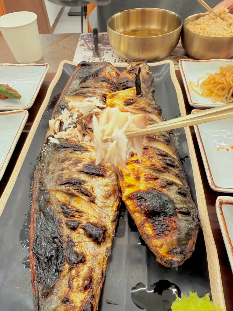 Table spread of basic side dishes including japchae and chonggak kimchi