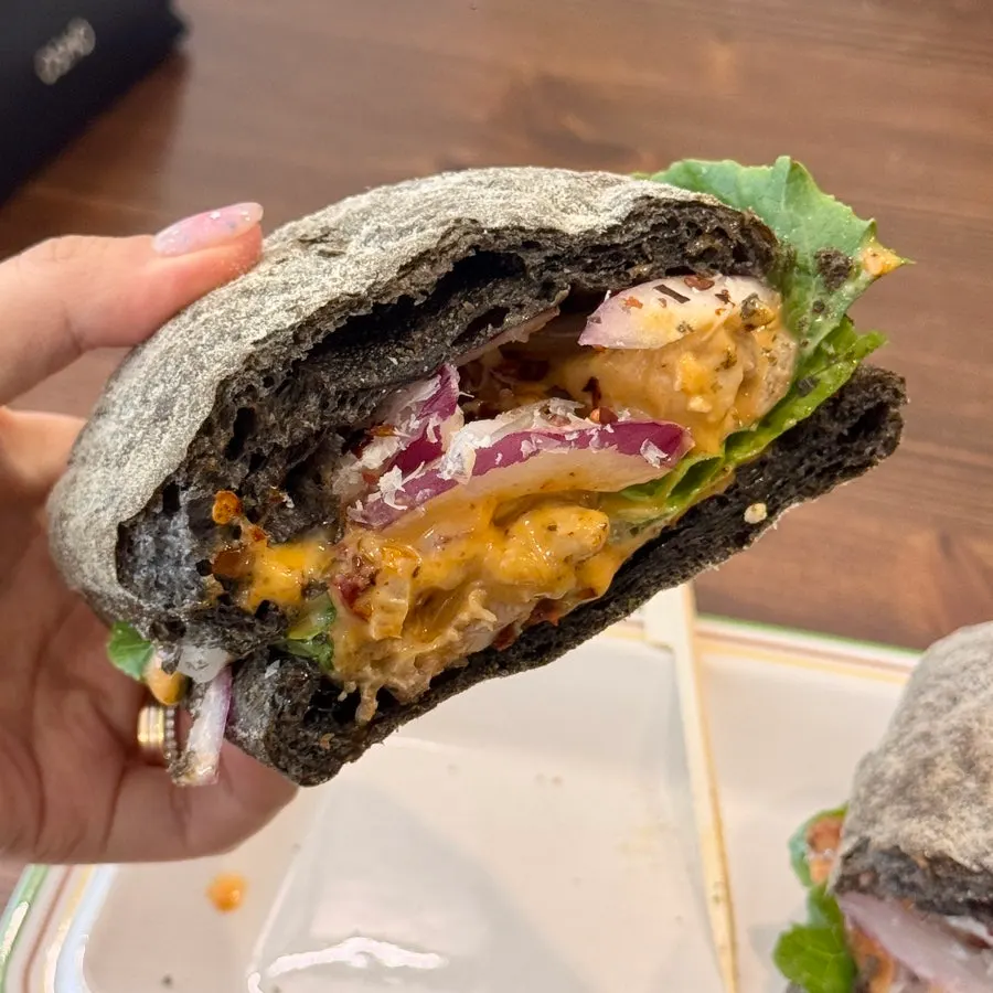 Spicy chicken sandwich with a bite taken out