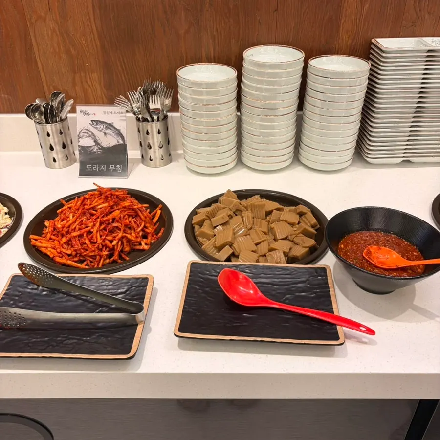Self-service bar with side dishes for grilled fish