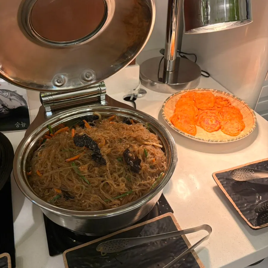 Self-service bar foods including tteokbokki and japchae