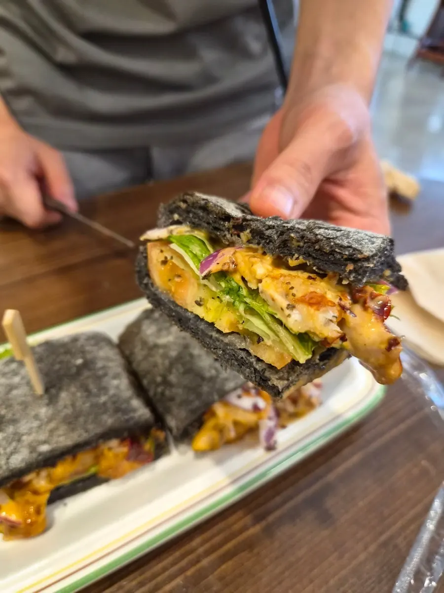 Spicy chicken sandwich with a bite taken out