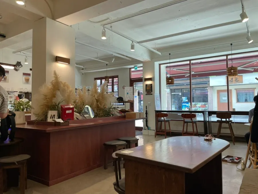 Saechamcoffee's seating extending toward the back of the café