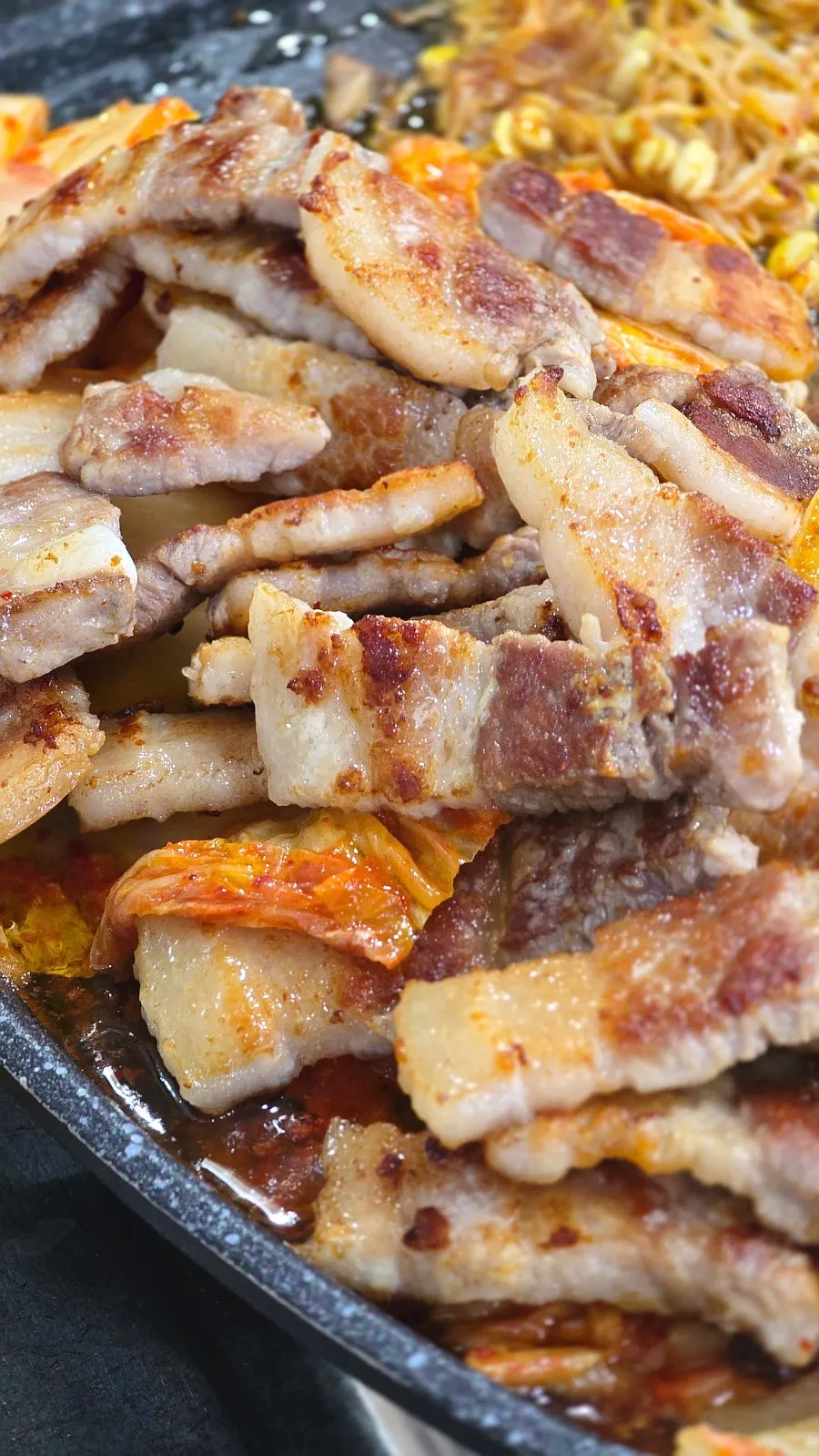 Vertical shot of juicy grilled pork belly